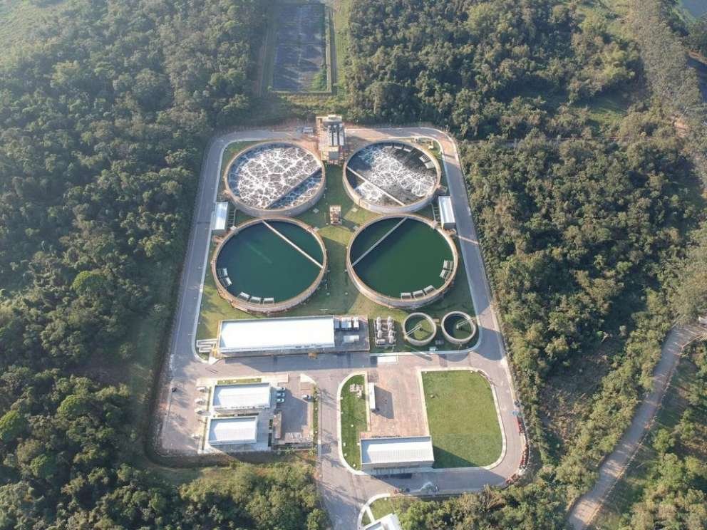 Vista aérea de uma Estação de Tratamento de Esgoto (ETE), estrutura fundamental do saneamento básico responsável pelo tratamento do esgoto antes de sua devolução ao meio ambiente.